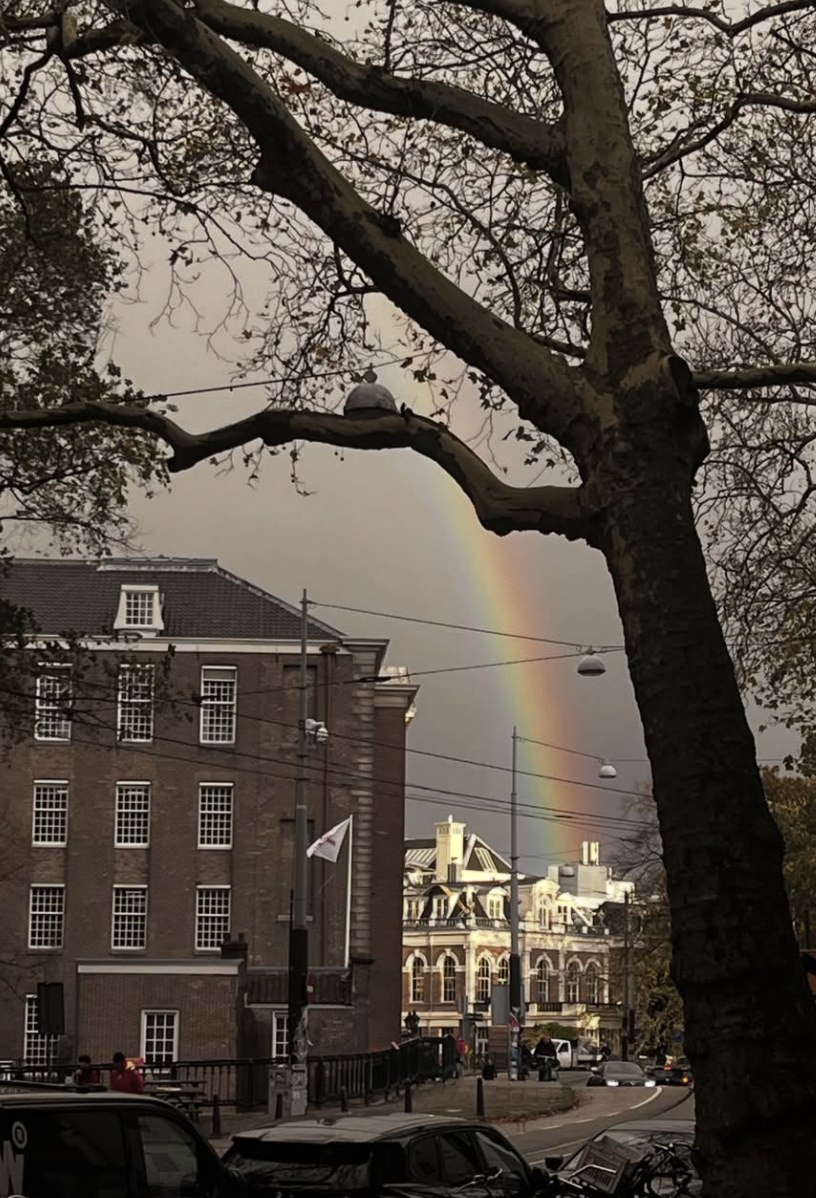 A rainbow above the street next to the café in Amsterdam