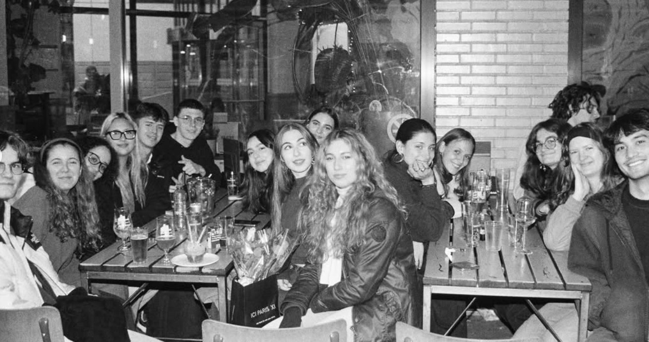 A large group of friends at the tables outside De Krater
